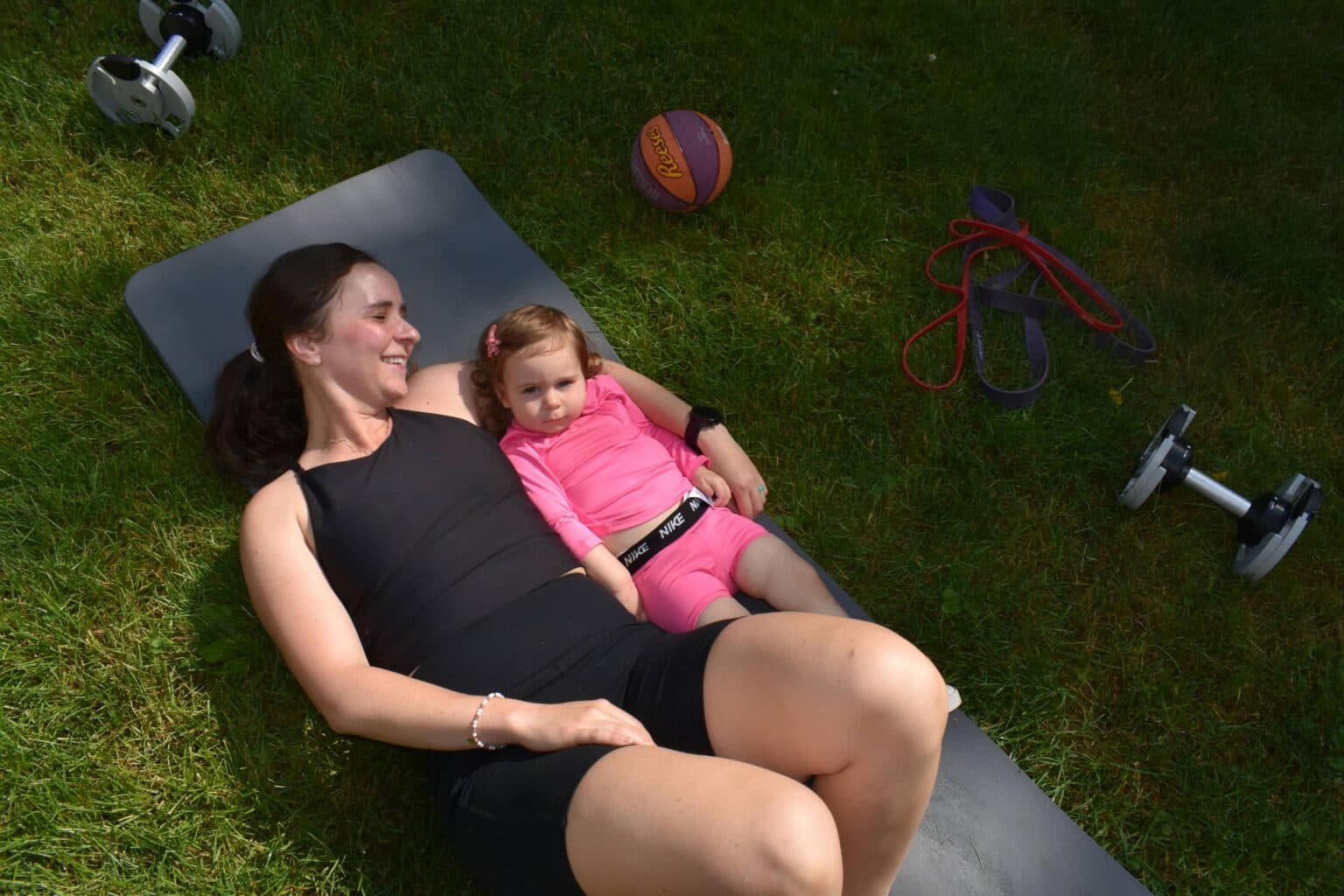 Lexi training a mom outdoors with her child nearby in the Lehigh Valley